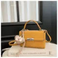 Vintage yellow PU leather small square handbag featuring the top handle and heart charm. - With Pendant / Yellow
