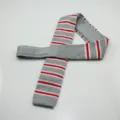 Men's knitted flat-end necktie featuring stylish grey, red, and white horizontal stripes. - Gray Striped