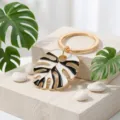 Monstera leaf keychain, black and white enamel key ring, gold tone metal bag pendant. - Black