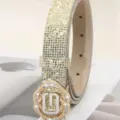 Close-up of sparkling rhinestone women belt with metal buckle, crystal details. - Gold