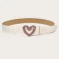 Close-up detail of the stylish white belt featuring a sparkling pink rhinestone heart buckle. - White