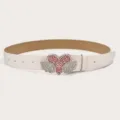 Detail view of the white leather belt featuring a dazzling rhinestone heart and wings buckle. - White