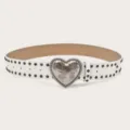 White studded leather belt for women featuring a metal heart buckle with floral engraving. - Length 105cm Width 3.8cm / White