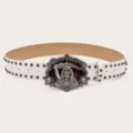 Vintage punk style white leather belt with detailed metal skull buckle and cool double row studs. - White