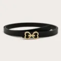 Closeup of stylish black leather belt with gold heart buckle, versatile accessory for jeans. - Black