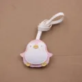 Primer plano detallado del lindo colgante de pingüino de cuero rosa y blanco con correa. - Adorno de Bolso (Colgante Bebé Pingüino) / Rosa