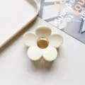 Close-up of glossy cream flower hair claw clip, durable resin with metal spring detail. - Flower Hair Clip / Solid Beige White