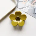 Close up detail of the glossy mustard yellow flower hair claw clip on white background surface. - Flower Hair Clip / Solid Mustard Yellow