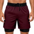 Detailed view of men's 2-in-1 athletic running shorts with elastic drawstring waistband. - Burgundy