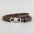 Detailed close-up of a brown genuine leather women belt featuring a sleek silver knot buckle. - Coffee