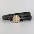 Close-up of slim black leather belt featuring a dazzling gold-tone rhinestone floral buckle. - 100cm / Black