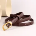 Close-up of a minimalist brown leather women's belt featuring a unique gold tone irregular buckle. - Coffee / 100cm