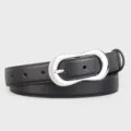 Detailed shot of black leather belt with silver irregular buckle, elegant and versatile accessory. - 100cm / Black