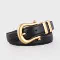 Black leather belt detail showcasing the elegant gold horseshoe buckle and refined metal loops. - Black