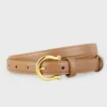 Brown leather belt detail shot showcasing a polished gold-tone horseshoe buckle accessory. - Brown / 100cm