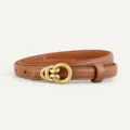 Close-up detail shot of a brown leather women belt featuring a vintage gold-toned metal buckle. - Brown