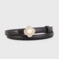Detail view of the black genuine leather thin belt featuring a pearl clover metal buckle. - Black