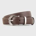 Detail shot of brown leather belt with silver buckle, premium craftsmanship and texture. - 100cm / Coffee