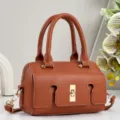 Brown leather shoulder bag detail, featuring elegant gold hardware and classic texture. - Earthy Yellow