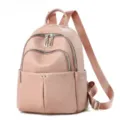 Détail du sac à dos en cuir rose crème, poches multiples zippées et bretelles tressées réglables. - Rose