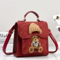 Red PU leather mini backpack handbag with cute knit bear patch and tiny hat, detailed view - Red