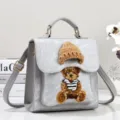 Gray PU leather mini backpack handbag featuring cute knitted bear and hat detail. - Gray