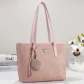 Elegante borsa a spalla da donna rosa shopper con ciondolo intrecciato e logo metallico. - Rosa