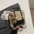 Retro college style small backpack with cute rabbit doll pendant, chic commuter casual bag. - With Pendant / Beige And Black