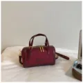 Burgundy Boston bag for women, stylish faux suede handbag with top handle and crossbody strap. - No Pendant / Red