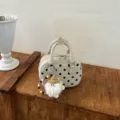 Chic polka dot bowling handbag with cute plush charm, stylish shoulder bag for daily commuting. - With Pendant / White