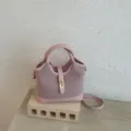Stylish pink women bucket handbag and shoulder crossbody bag with elegant metal lock closure. - No Pendant / Pink