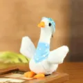 Cute white plush duck toy with blue hat and bib, soft stuffed animal gift for kids and girls. - Blue