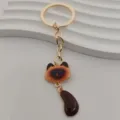 Close-up detail of the cute cat keychain featuring golden metal finish and charming brown tail. - Blue-Eyed Dark Brown Ear Cat Style (7)