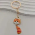 Cute metal cat keychain with striped tail and big face pendant, stylish bag key ring accessory. - Orange and White Striped Cat Style (2)