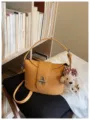 Chic yellow lychee pattern bucket bag with cute bear pendant and turn-lock closure. - With Pendant / Yellow