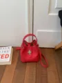 Red leather bucket bag for women, stylish top handle handbag with chic metal lock closure. - No Pendant / Red