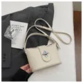 Pebbled leather crossbody bag in beige, elegant minimalist design for daily commute. - No Pendant / Off White