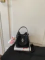 Black pebbled leather bucket bag, stylish commuter shoulder handbag with turn-lock. - With Charm / Black