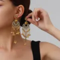 Detail view of vintage bohemian gold tassel earrings with rhinestones and hollow floral charm. - Petal Tassel Style (weh6388) / Champagne Antique Gold