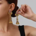 Close-up detail shot of vintage gold-tone jhumka earrings with red stone and dangling bells. - Hollow Bell Style (weh6382) / Rose Red Antique Gold