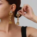 Detailed close-up of vintage ethnic gold dangle earrings featuring intricate bells. - Hollow Bell Style (weh6382) / White Antique Gold