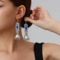 Close-up detail of vintage silver jhumka earrings featuring blue square crystal and bell tassels. - Square Rhinestone Tassel Style (weh6384) / Royal Blue Antique Silver