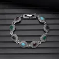 Vintage silver tone bracelet detail showcasing multi-color teardrop stone charms. - Vintage Style L740-3