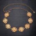 Detailed view of a vintage gold metal floral waist chain belt with delicate flower charms for dresses. - Large Flower Stud / Gold
