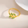 Portatovaglioli in lega dorata con design a foglia di strass verdi per decorare la tavola. - Foglia (X1132-12)