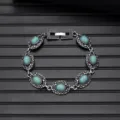 Detailed view of vintage silver turquoise bracelet with intricate carved links and secure clasp. - Vintage Style L740-8