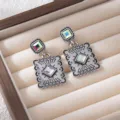 Vintage style geometric drop earrings with iridescent crystal stones detailed shot. - Silver