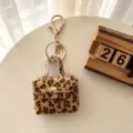 Porte-clés mini sac à main en fausse fourrure léopard et étui écouteurs variante. - Café Clair