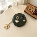 Donkergroene ronde opvouwbare make-upspiegel sleutelhanger met ballerinamotief. - Legergroen