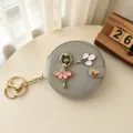 Leuke balletmeisje ronde make-up spiegel sleutelhanger, draagbare opvouwbare zakspiegel. - Grijs